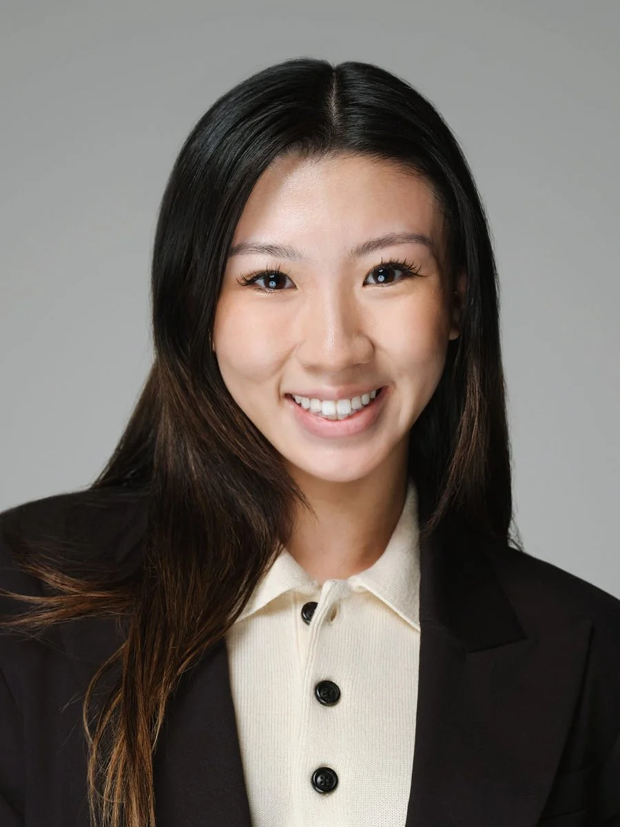 studio-headshot-nyc-woman-white-blazer-gray-background.jpg