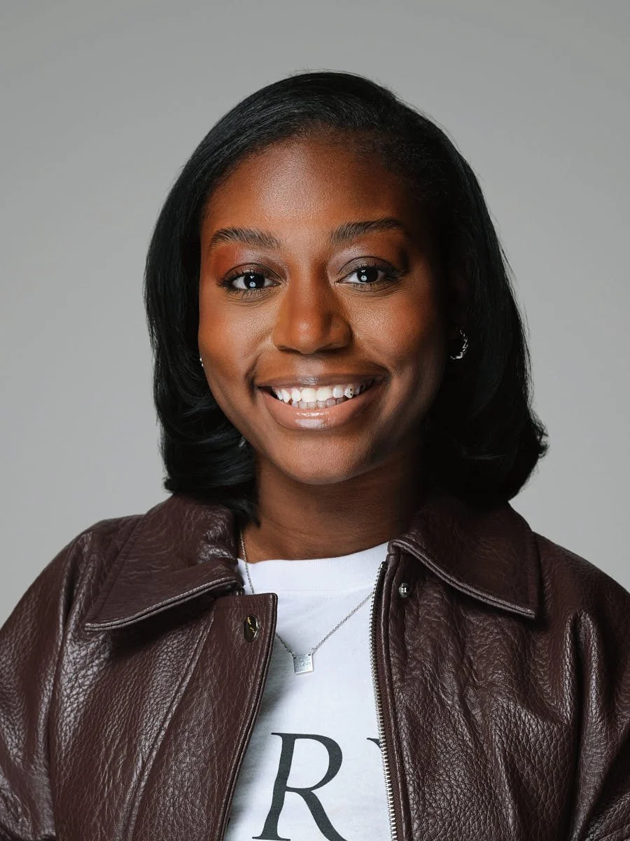headshots-nyc-woman-leather-jacket-gray-background.jpg