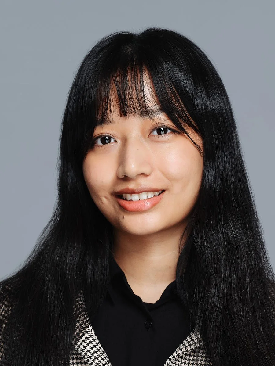 studio-headshot-nyc-woman-black-hair-gray-background.jpg