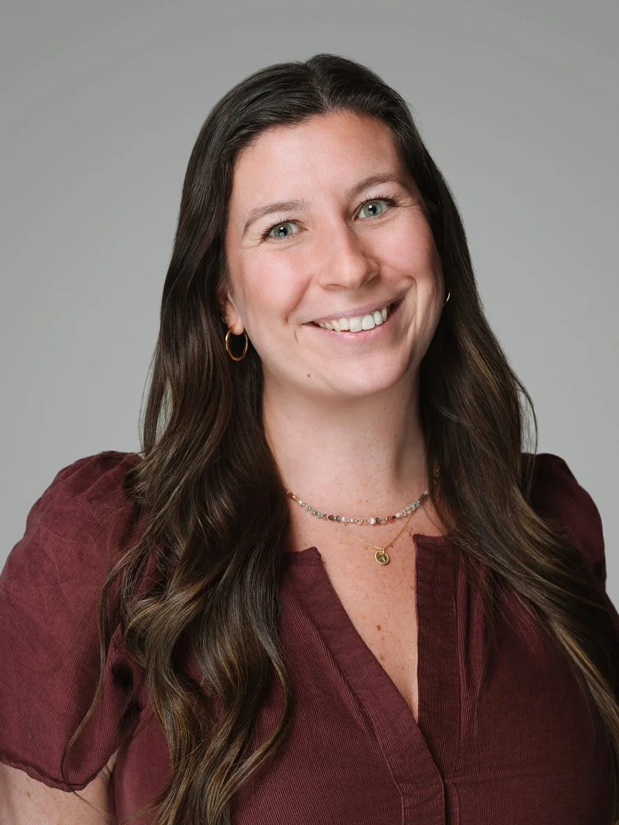 business-portrait-nyc-woman-maroon-cardigan-gray-background.jpg
