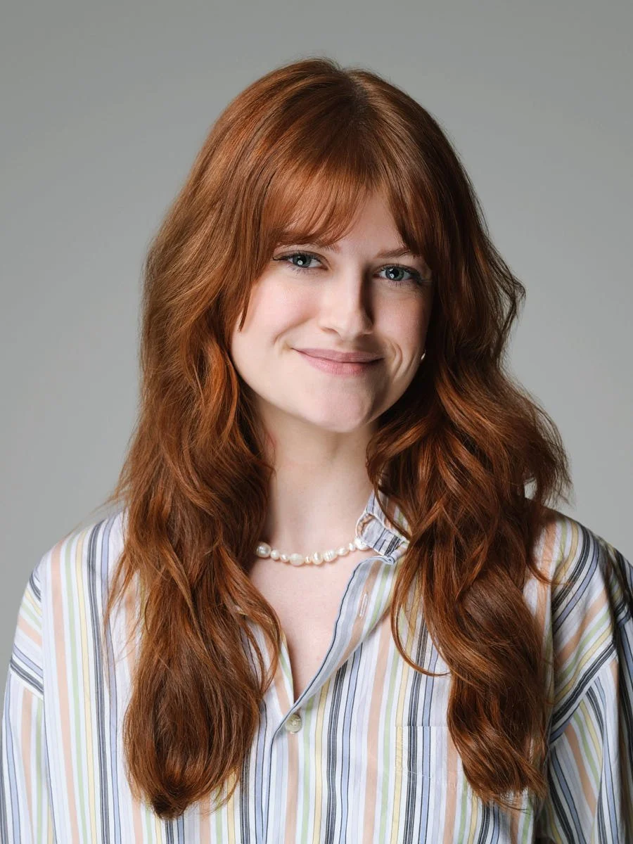 corporate-headshot-nyc-woman-red-hair-gray-background.jpg