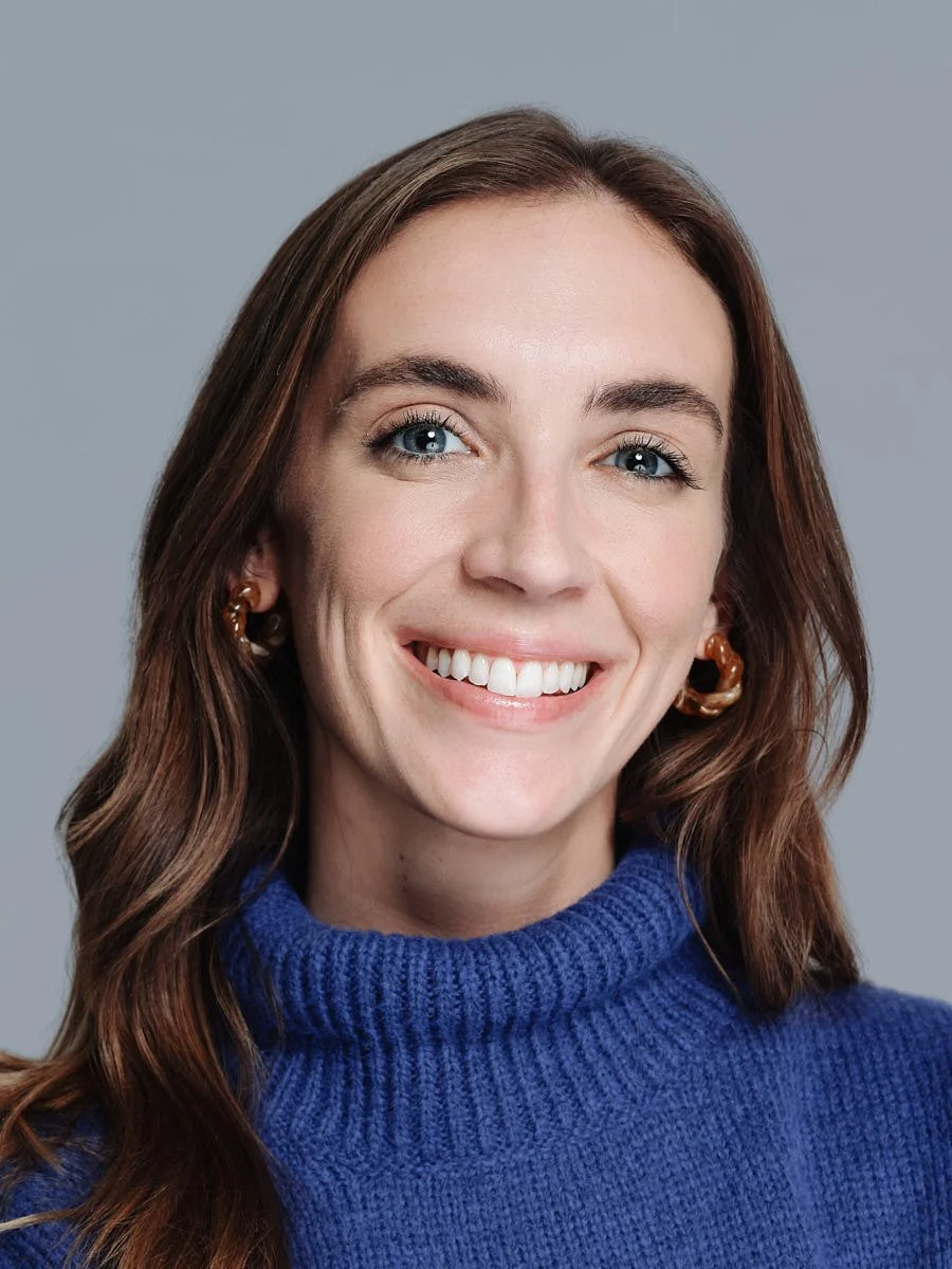 headshots-nyc-woman-blue-sweater-gray-background.jpg