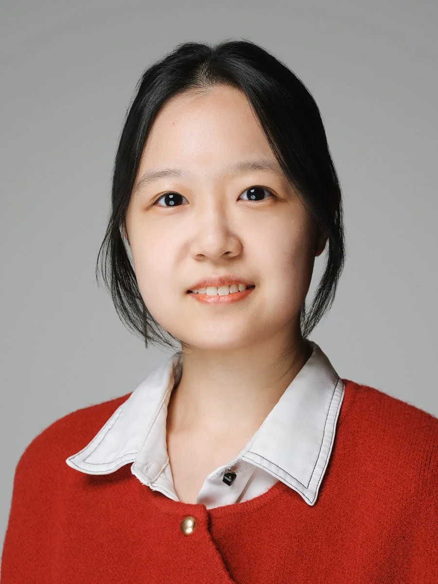 headshots-nyc-woman-red-cardigan-gray-background.jpg