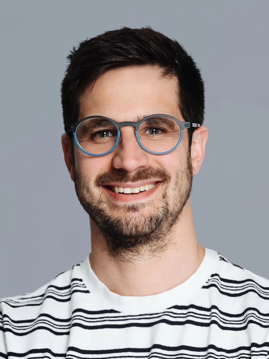 corporate-headshot-nyc-man-striped-shirt-gray-background.jpg