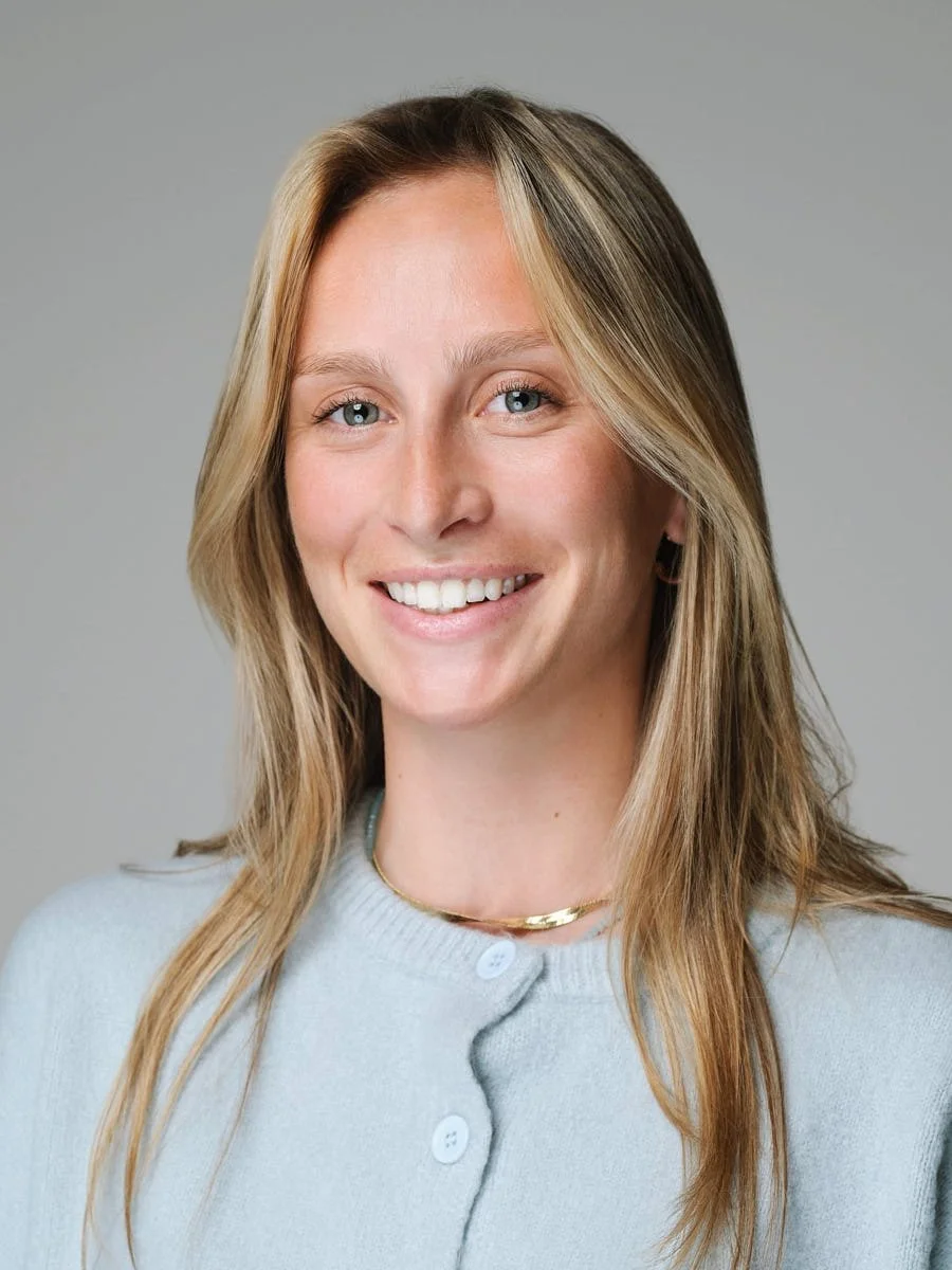 headshots-nyc-woman-light-blue-cardigan-gray-background.jpg