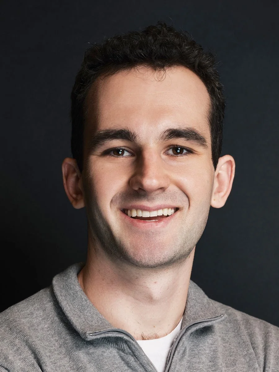 professional-headshot-nyc-man-gray-polo-dark-background.jpg