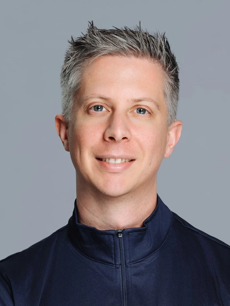 corporate-headshot-nyc-man-silver-hair-navy-quarter-zip.jpg