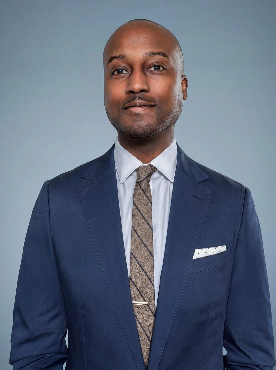 Remote team portrait in a blue suit against a blue-gray background.