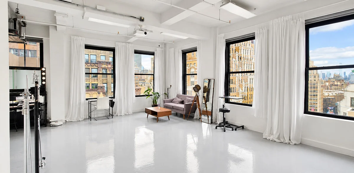 Studio stands and a portrait setup beside the curtain-lined windows in our Midtown studio.